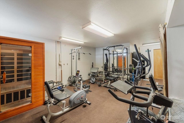 workout room with a textured ceiling