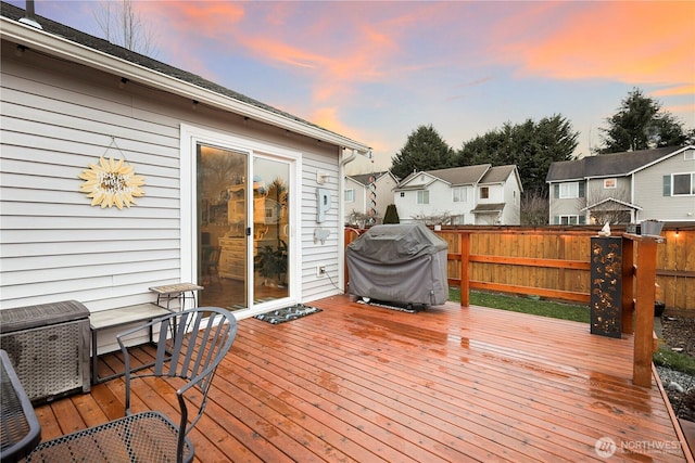 deck at dusk with area for grilling