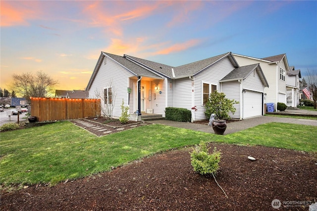 view of front facade with a garage and a yard