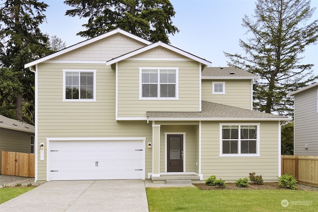 view of front of property featuring a garage and a front lawn