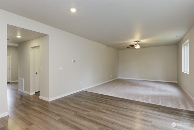 empty room with ceiling fan and light wood-type flooring