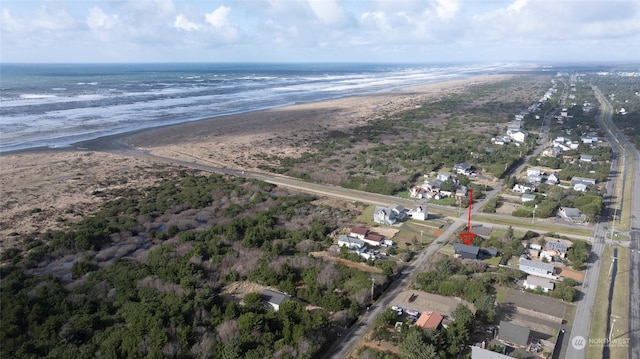 bird's eye view with a water view and a beach view