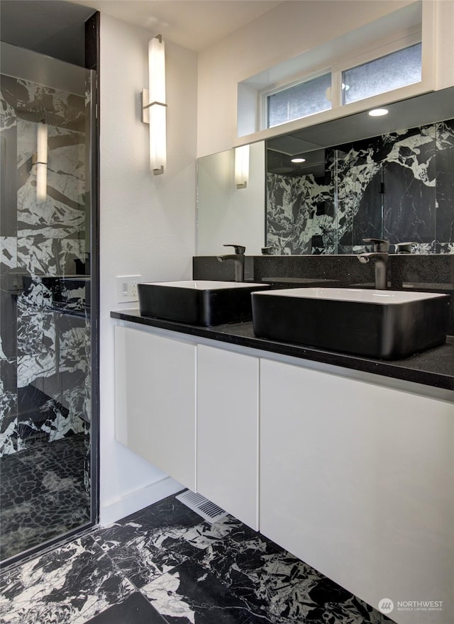 bathroom with vanity and a shower with shower door