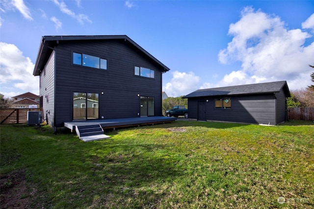 rear view of house featuring a deck, a yard, and central AC unit