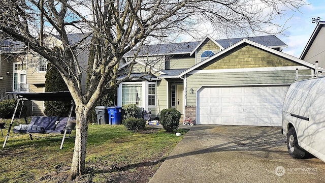 view of front of house featuring a garage and a front yard