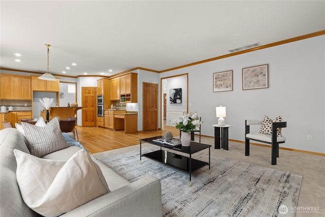 living area featuring visible vents, baseboards, recessed lighting, and crown molding