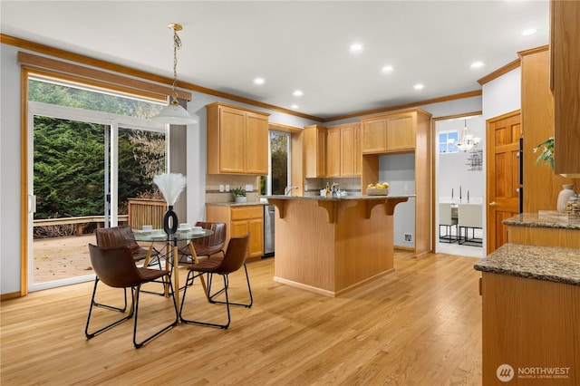 kitchen featuring light wood-style floors, light stone countertops, and a healthy amount of sunlight