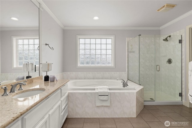 full bathroom with crown molding, vanity, visible vents, a bath, and tile patterned floors