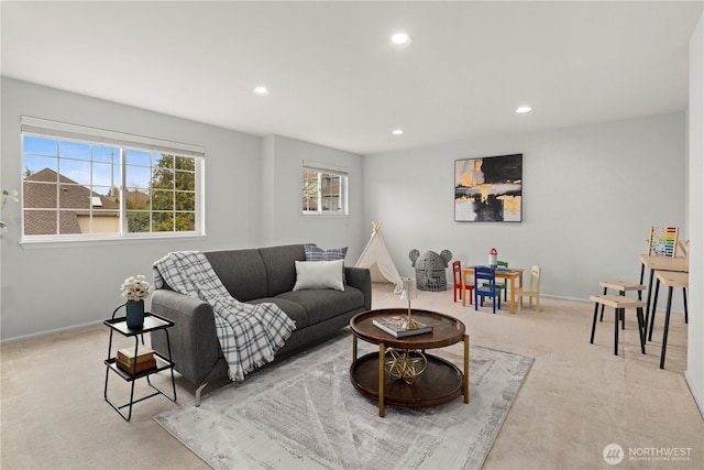 living area with baseboards, recessed lighting, and light carpet