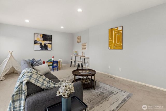 living room with recessed lighting, visible vents, baseboards, and carpet