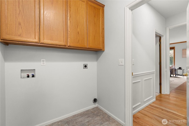 washroom with cabinet space, electric dryer hookup, baseboards, light wood-style flooring, and washer hookup