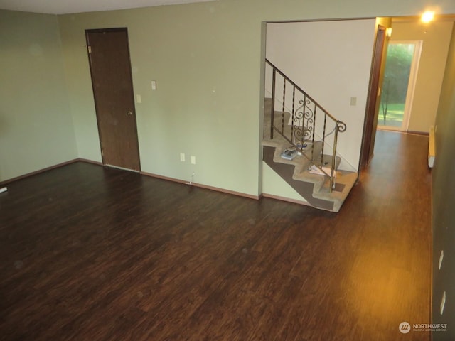 unfurnished room with dark hardwood / wood-style floors