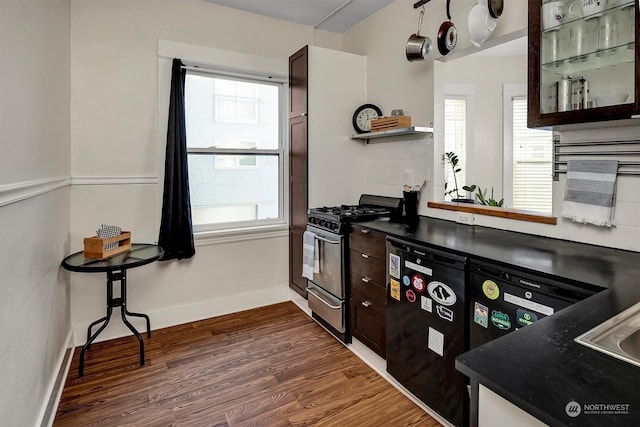 kitchen with dark hardwood / wood-style flooring, gas range, dark brown cabinets, and dishwasher