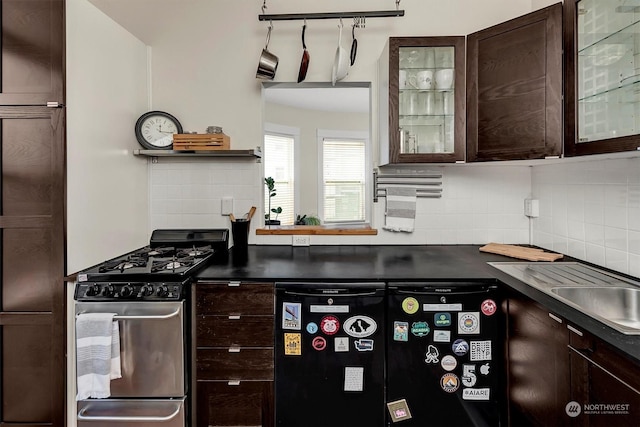 kitchen featuring dark brown cabinetry, tasteful backsplash, and gas stove