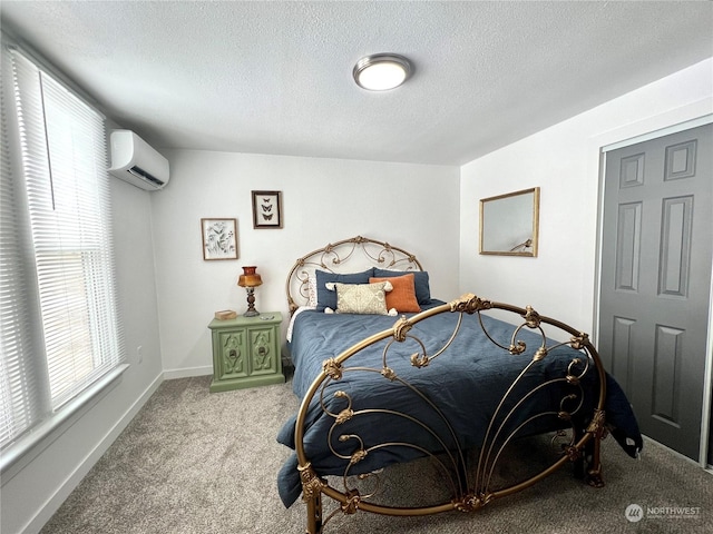 bedroom featuring a textured ceiling, carpet, and an AC wall unit