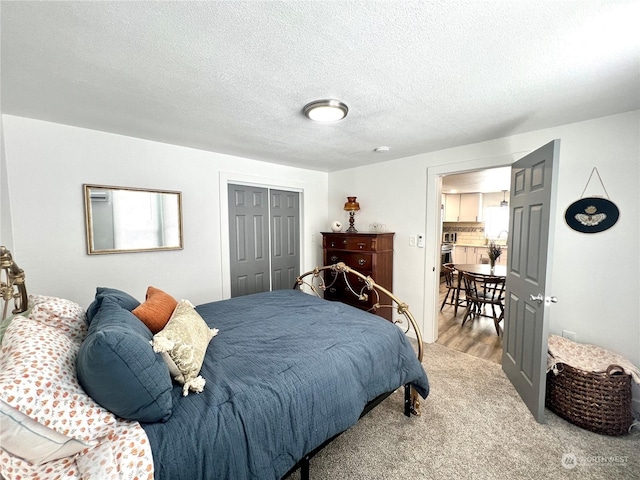 bedroom featuring hardwood / wood-style floors, a textured ceiling, and a closet