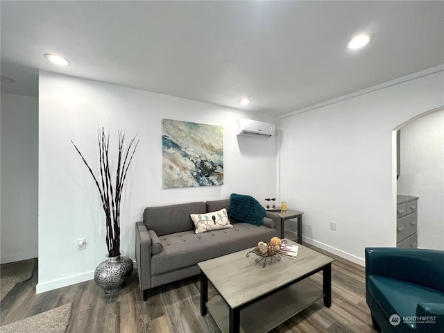 living room with wood-type flooring and a wall unit AC