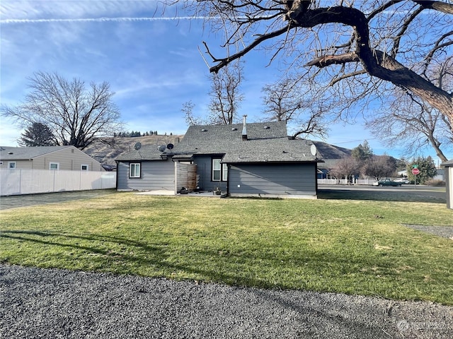 rear view of house with a lawn