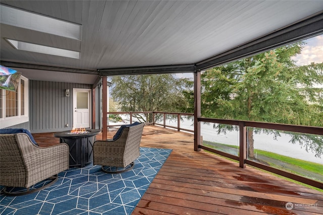 wooden terrace featuring an outdoor fire pit