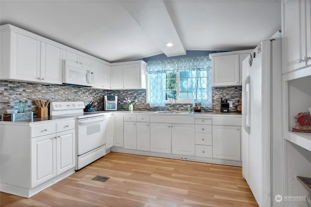 kitchen with white cabinetry, white appliances, light hardwood / wood-style floors, and sink