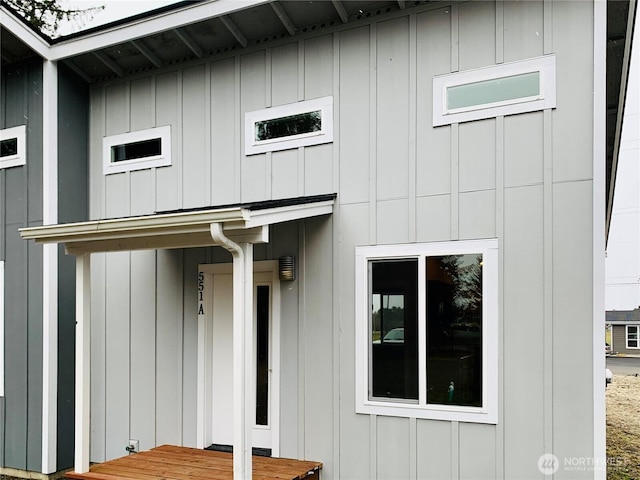 view of exterior entry with board and batten siding