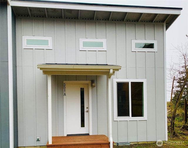 view of exterior entry featuring board and batten siding