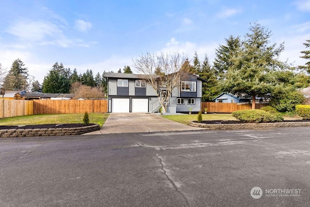 view of front of home with a garage and a front lawn