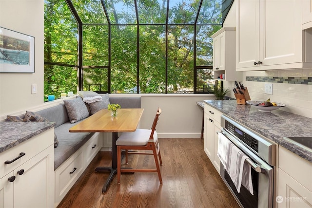 interior space with breakfast area and dark hardwood / wood-style floors