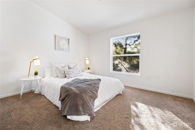 bedroom featuring vaulted ceiling and carpet floors