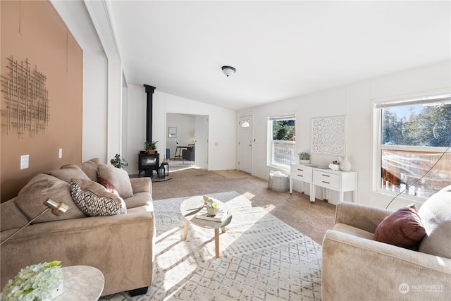 carpeted living room with a wood stove