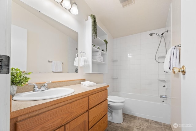 full bathroom with vanity, toilet, and tiled shower / bath combo