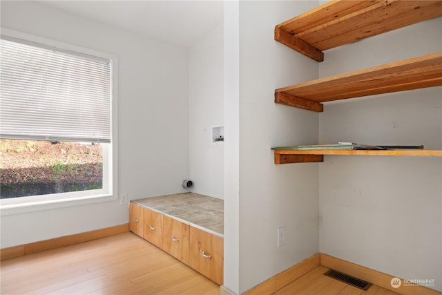 laundry area featuring hookup for an electric dryer, washer hookup, and light hardwood / wood-style floors