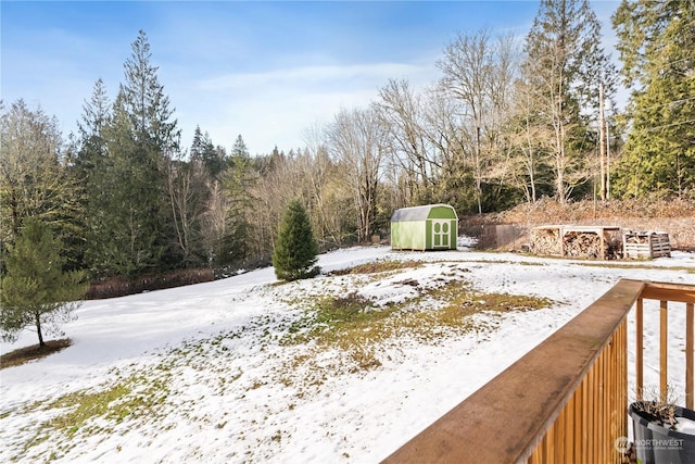 snowy yard with a shed