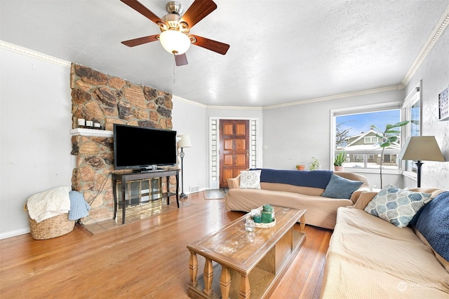 living room with hardwood / wood-style floors, ornamental molding, a textured ceiling, and ceiling fan