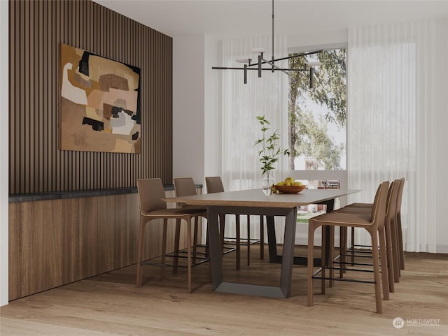 dining space with a notable chandelier and light wood-style floors