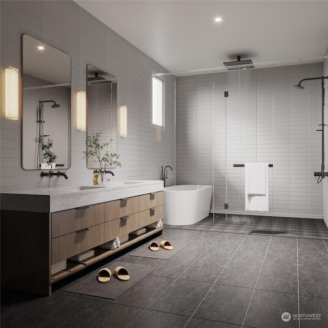 bathroom with double vanity, a stall shower, tile patterned floors, a freestanding bath, and tile walls