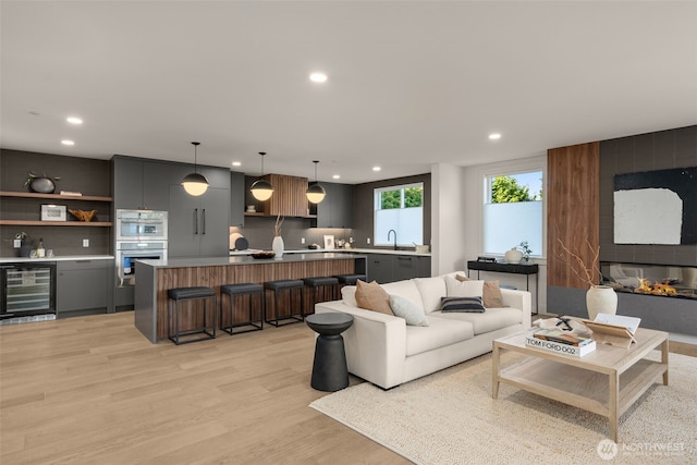 238 4th Ave Unit 100, Kirkland, WA 98033 - living room featuring wine cooler, recessed lighting, light wood-style flooring, and bar