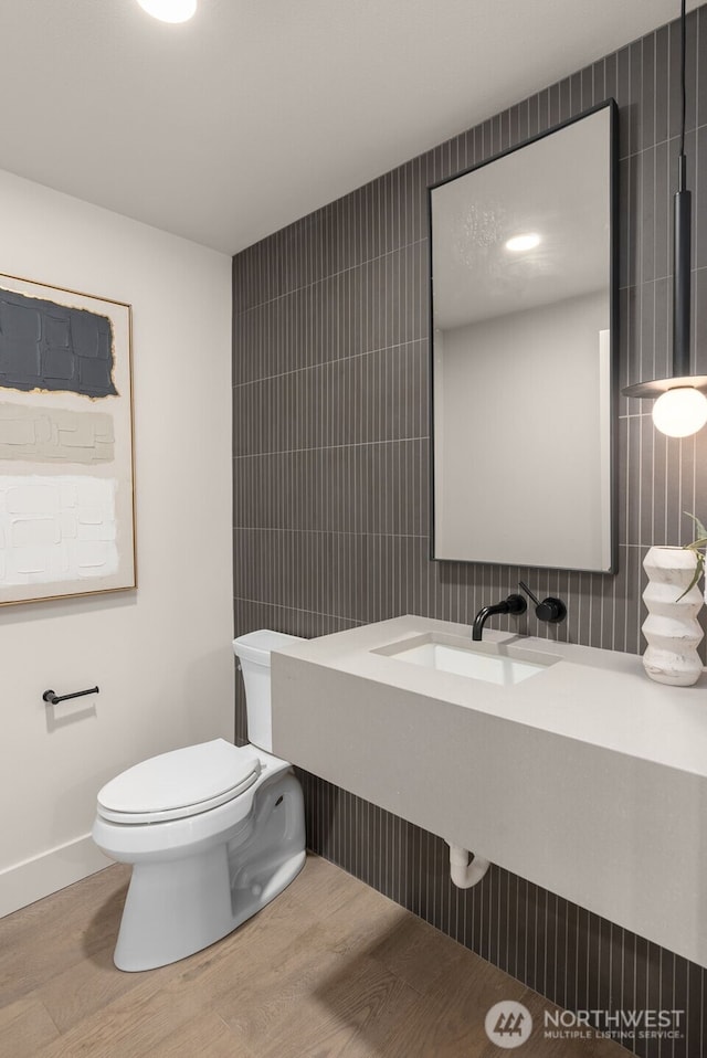 238 4th Ave Unit 100, Kirkland, WA 98033 - bathroom with tile walls, wood finished floors, and tasteful backsplash
