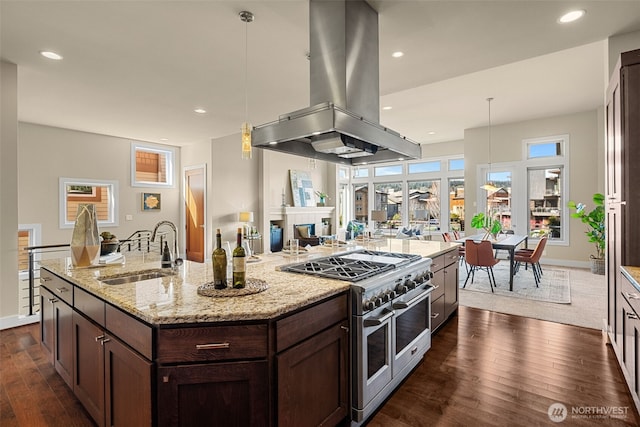 1026 N 41st Pl, Renton, WA 98056 - kitchen featuring island exhaust hood, dark wood finished floors, dark brown cabinetry, a sink, and range with two ovens