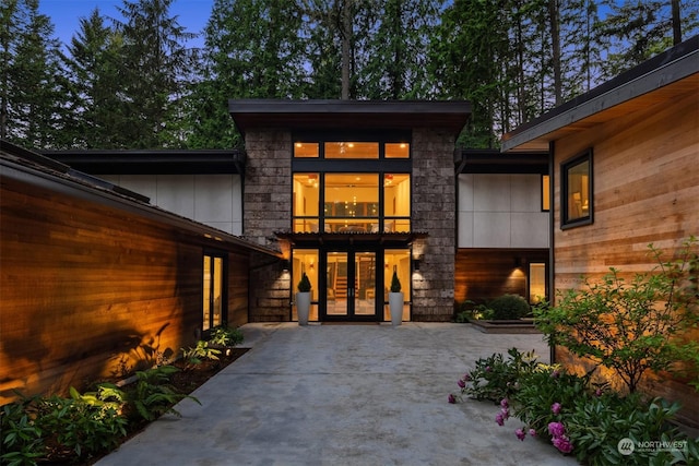 property entrance with a patio area and french doors