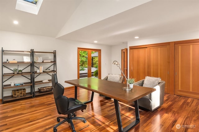 office area featuring vaulted ceiling with skylight, hardwood / wood-style floors, and french doors