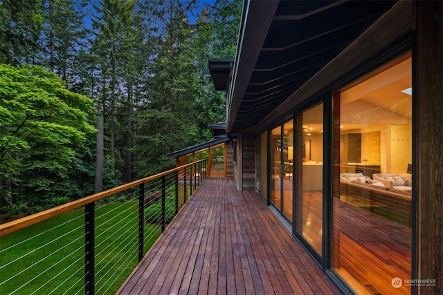 wooden terrace featuring a lawn