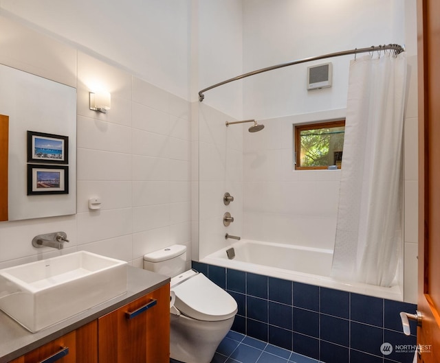 full bathroom featuring vanity, tile walls, shower / bathtub combination with curtain, and toilet