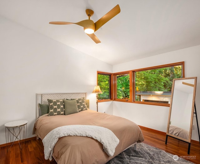 bedroom with vaulted ceiling, hardwood / wood-style floors, and ceiling fan