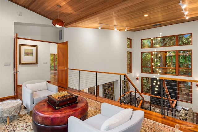 living room with hardwood / wood-style flooring, lofted ceiling, track lighting, and wood ceiling