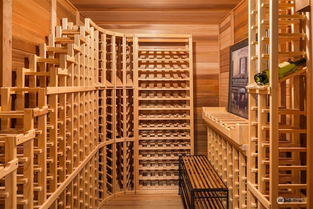 wine cellar with hardwood / wood-style flooring, wooden ceiling, and wood walls