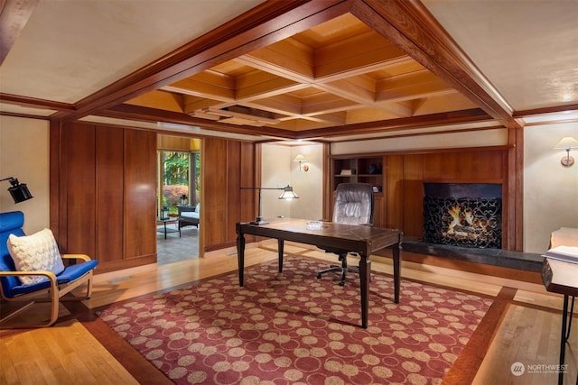 home office featuring ornamental molding, coffered ceiling, hardwood / wood-style floors, and beam ceiling