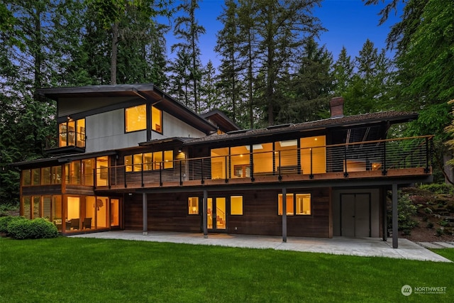 back of property with a patio, a yard, and a deck