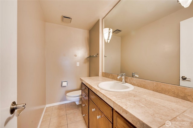 bathroom featuring vanity, tile patterned floors, and toilet