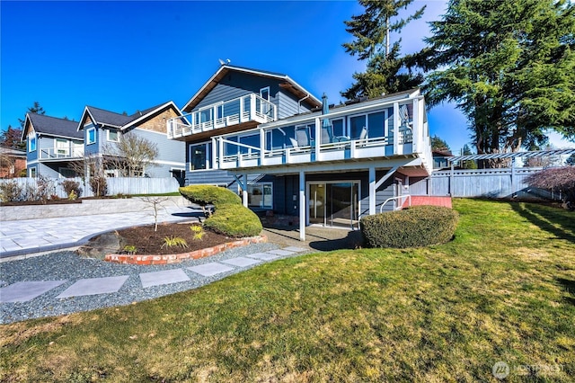 back of property featuring a lawn and a patio area